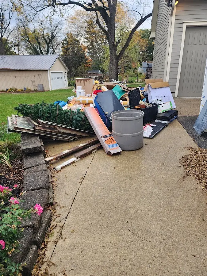 Dumpster being loaded with debris for Estate Cleanout Dumpster Rental in Fort Dodge